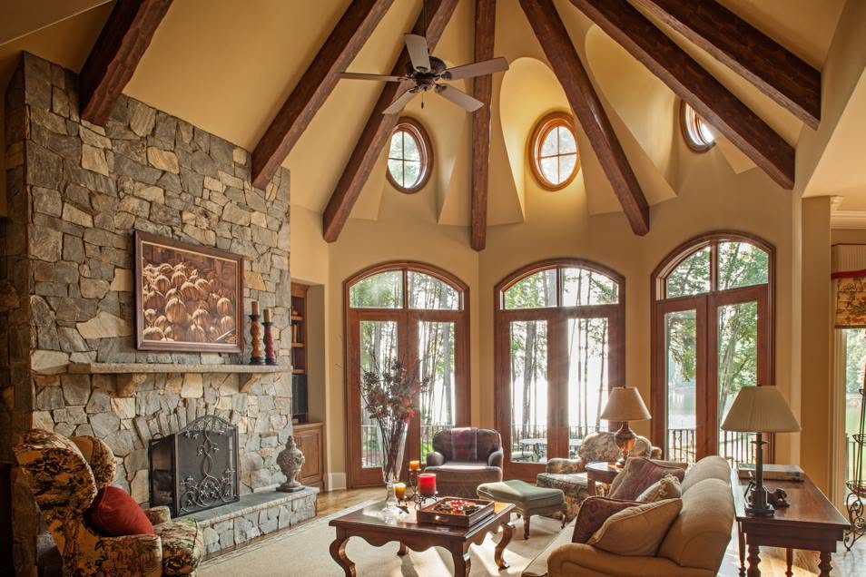 Great room interior with a floor-to-ceiling stone fireplace and vaulted wood ceiling