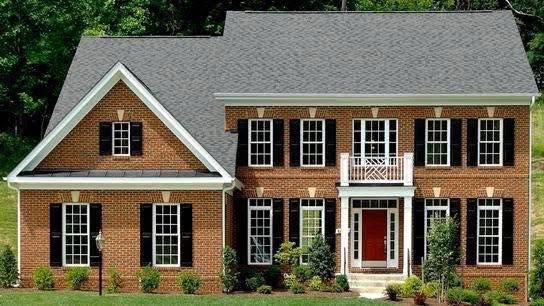 Brick colonial custom home with white trim built by Pearl Construction