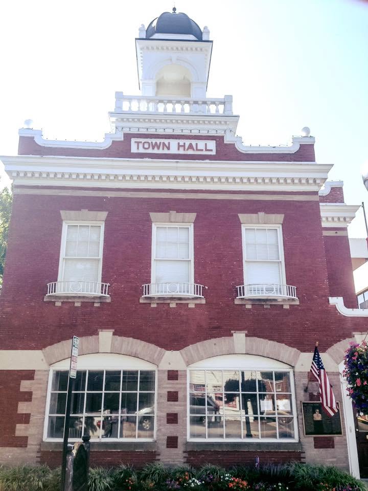 Historic brick municipal town hall building with clock tower