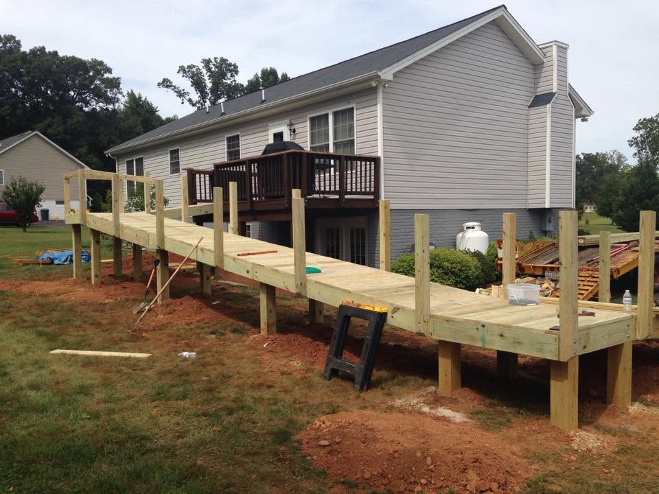 Pressure-treated wood deck addition on the back of a home