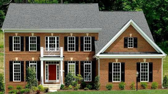 Brick colonial custom home with mature landscaping built by Pearl Construction