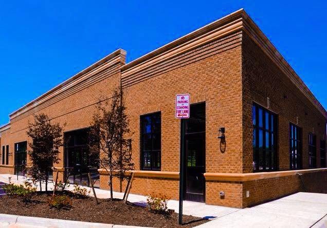 Single-story commercial brick building with a covered entrance
