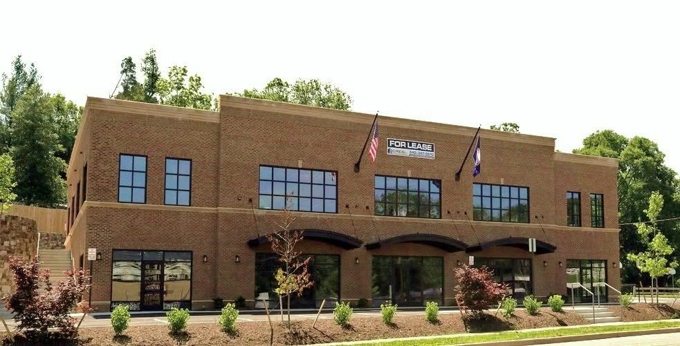 Commercial brick office building with parking area